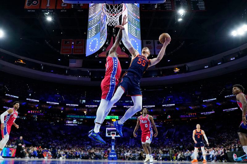 New York Knicks' Isaiah Hartenstein, right, goes up for a shot against Philadelphia 76ers' Joel Embiid during the second half of Game 4 in an NBA basketball first-round playoff series, Sunday, April 28, 2024, in Philadelphia. (AP Photo/Matt Slocum)