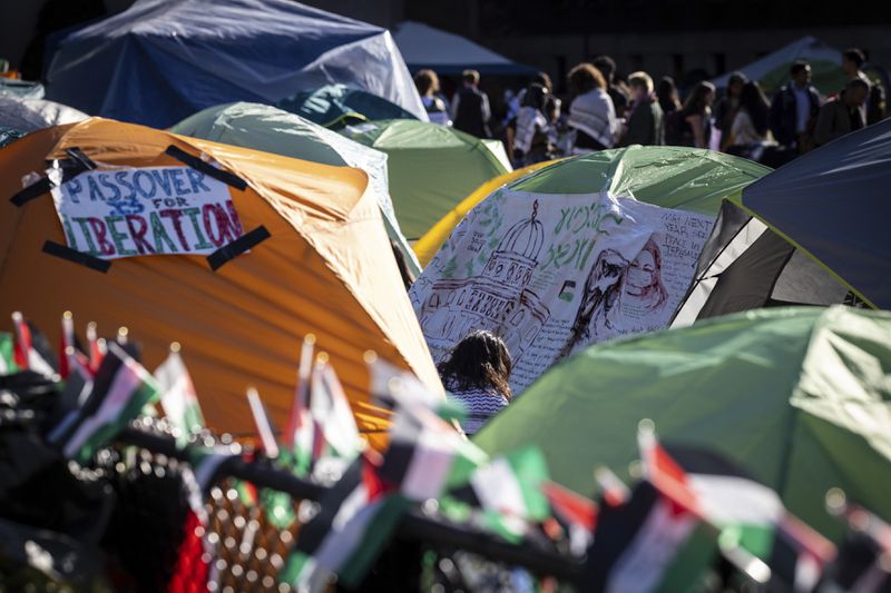 Signs are displayed on tents at the pro-Palestinian demonstration encampment at Columbia University in New York on Wednesday April 24, 2024. (AP Photo/Stefan Jeremiah)