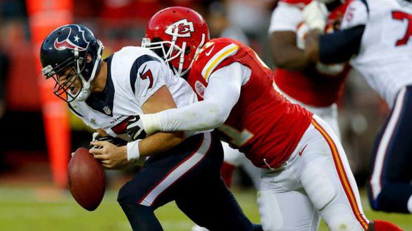 THE ASSOCIATED PRESS Kansas City linebacker Tamba Hali, right, forces Houston quarterback Case Keenum to fumble during the waning moments of Sunday's game at Arrowhead Stadium. Derrick Johnson recovered the fumble to seal the Chiefs' 17-16 victory, their seventh straight to open the season.