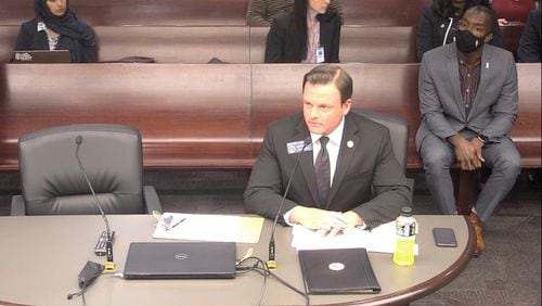 State Sen. Clint Dixon addresses a Senate panel concerning changes he wants in Gwinnett County elections. Gwinnett school board Chairman Everton Blair and Gwinnett County Chairwoman Nicole Love Hendrickson, seated behind him, opposed the measure.