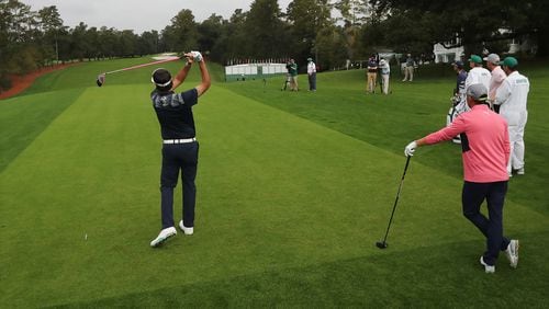 Bubba Watson tees off on the first hole with Rickie Fowler looking on to begin their practice round Tuesday at Augusta National.