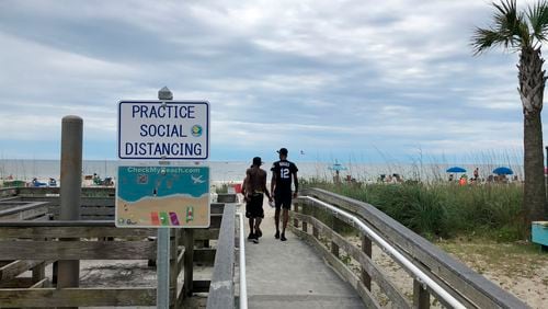 A sign in Myrtle Beach, South Carolina, asks people to maintain social distancing on the beach.
