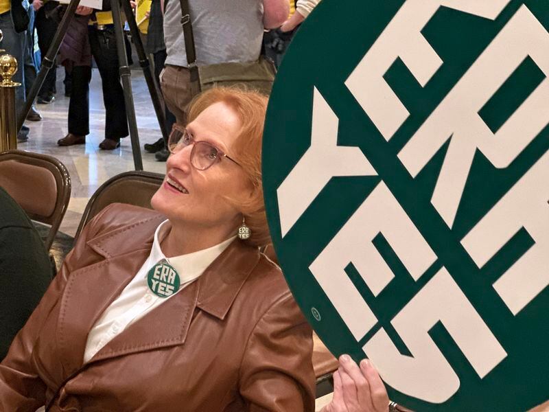 Betty Folliard, an advocate for the proposed Minnesota Equal Rights Amendment and the founder of ERA Minnesota, holds a green sign that says "ERA YES" during a rally in support of the proposal, March 7, 2024, in the Minnesota Capitol building in St. Paul, Minn. The proposal would be among the most expansive protections of women's rights, abortion rights and LGBTQ rights in the nation if it is approved by lawmakers this session and then by Minnesota voters on the 2026 ballot. (AP Photo/Trisha Ahmed)