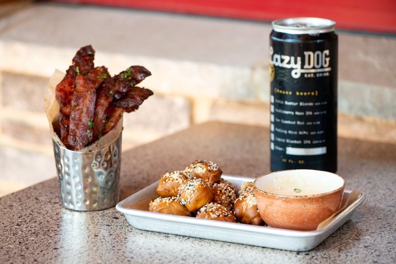 Cowgirl Cheese Dip and Pretzels, Bacon Candy, and a Lazy Dog crowler. Photo credit- Mia Yakel.