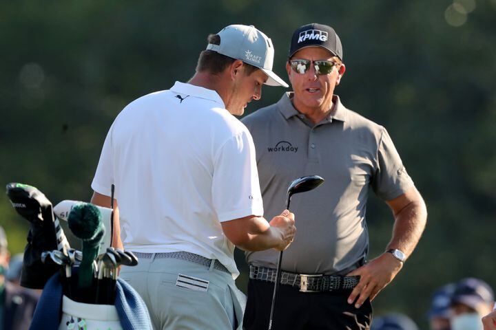 April 7, 2021, Augusta: Bryson DeChambeau, left, talks with Phil Mickelson on the tenth tee during their practice round for the Masters at Augusta National Golf Club on Wednesday, April 7, 2021, in Augusta. Curtis Compton/ccompton@ajc.com