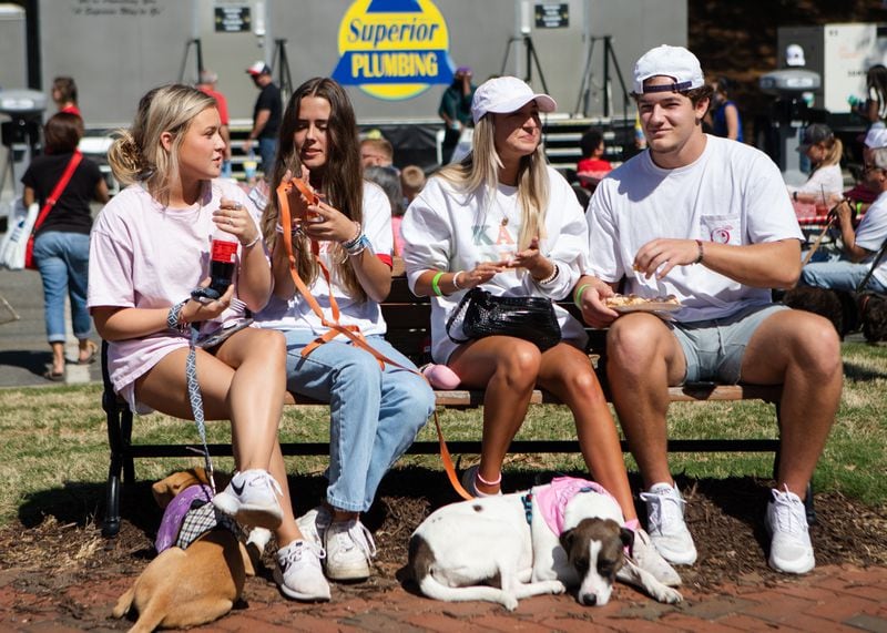 Anna Gray (from left), Katelyn Pasquarello, Skylar Williamson and Zac Sandman sit and eat on a park bench during the Big Shanty Festival on Saturday, April 17, 2021, in downtown Kennesaw, Georgia. CHRISTINA MATACOTTA FOR THE ATLANTA JOURNAL-CONSTITUTION