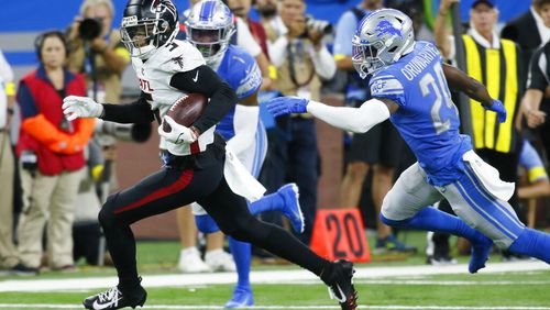 Falcons wide receiver Drake London runs ahead of Lions cornerback Amani Oruwariye during an exhibition game Aug. 12 in Detroit. London was injured and has not returned. (AP Photo/Duane Burleson)