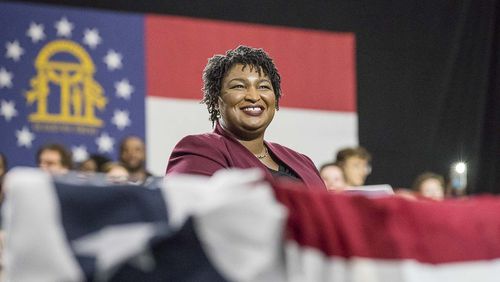 11/02/2018 -- Atlanta, Georgia -- Georgia Gubernatorial candidate Stacey Abrams listens as former President Barack Obama speaks during a rally for in Forbes Arena at Morehouse College, Friday, November 2, 2018. (ALYSSA POINTER/ALYSSA.POINTER@AJC.COM)