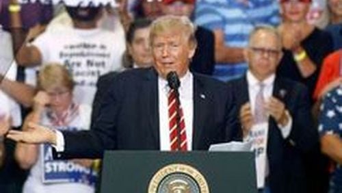 President Donald Trump gestures to the crowd as he speaks to supporters at the Phoenix Convention Center on Aug. 22, 2017. (Ralph Freso/Getty Images)