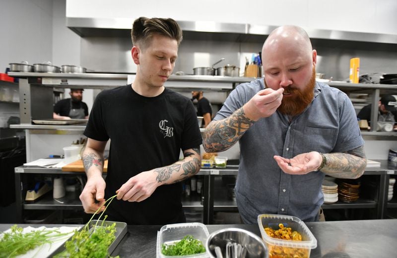 March 11, 2020 Atlanta - Chef Kevin Gillespie tests a food as executive sous chef Cody Chassar (left) looks at Cold Beer on Wednesday, March 11, 2020 (Hyosub Shin / Hyosub.Shin@ajc.com)