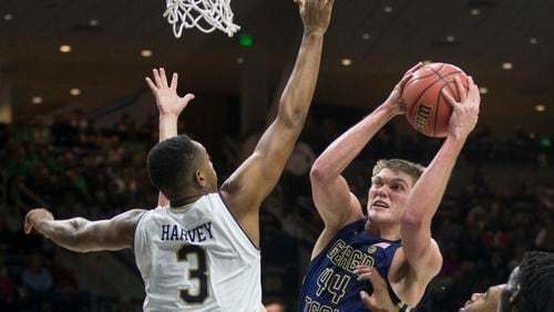 Georgia Tech's Ben Lammers (44) goes up for a shot as Notre Dame's D.J. Harvey (3) defends during the first half of an NCAA college basketball game Saturday, December 30, 2017, in South Bend, Ind. (AP Photo/Robert Franklin)