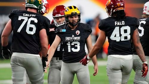 West kicker Jake Moody of Michigan, center, celebrates after making a field goal against East during the second half of the East-West Shrine Bowl NCAA college football game Thursday, Feb. 2, 2023, in Las Vegas. (AP Photo/John Locher)