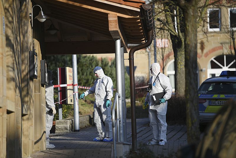 Crime scene investigators arrive on the scene Friday after a shooting left six people dead in the German town of Rot am See