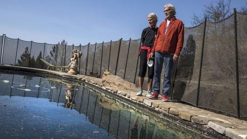 Jan and John Pascoe stand on the edge of the pool that saved their lives. The Santa Rosa, Calif., couple took refuge in their neighbor’s pool when a wind-driven wildfire engulfed their neighborhood last week in a matter of minutes.