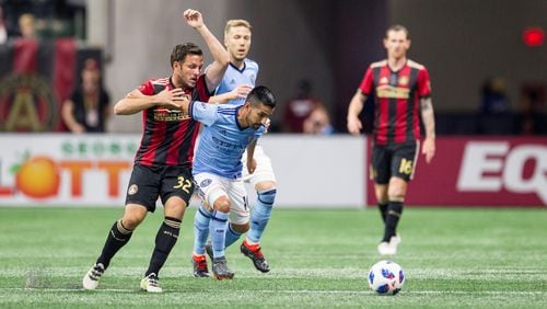 Atlanta United midfielder Kevin Kratz (32) attempts to get past NYC FC midfielder Maximliano Moralez (10) to get to the ball during the match between NYC FC and Atlanta United at Mercedes-Benz Stadium in Atlanta, Georgia, on Sunday, April 15, 2018. (REANN HUBER/REANN.HUBER@AJC.COM)