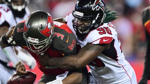Falcons defensive end Takkarist McKinley wraps up Buccaneers quarterback Jameis Winston to cause a fumble in the second quarter Dec. 18, 2017 at Raymond James Stadium in Tampa.
