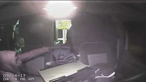 A surveillance photo shows someone robbing an ambulance in DeKalb County. (Credit: Channel 2 Action News)