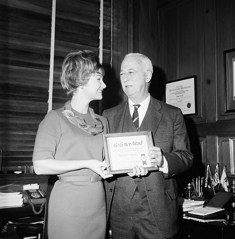Nov. 1965 -- Rich's department store head Richard H. Rich receives a Go-Getter Award from Linda Faye Carson.