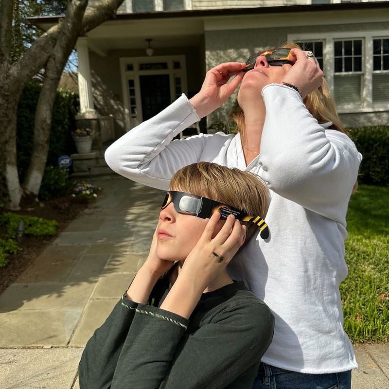 Inside Climate News senior editor Erin Schulte and her son Elliot Collier, 10, observe the maximum eclipse at 3:20 p.m. in Washington, D.C., when the moon obscured the sun by 89 percent. (Photo Courtesy of Kent Collier)