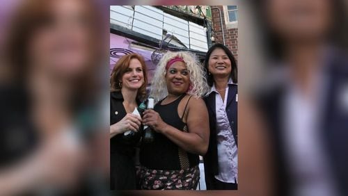 Kady DeWees and Mei Crowe pose for a photo with Blondie (center). AJC file photo: Bob Andres