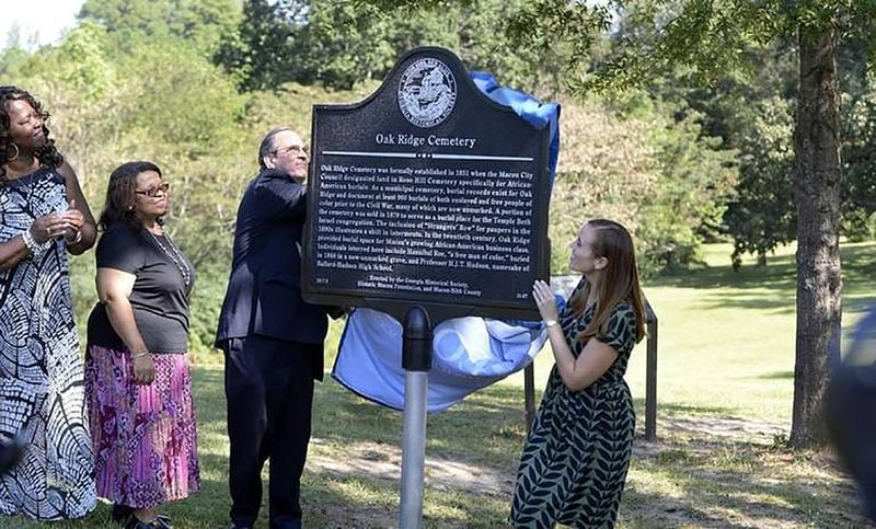 Commissioner Elaine Lucas and Macon-Bibb County cemetery specialist Marvia Mitchell watch Mayor Robert Reichert and Elyse Butler of the Georgia Historical Society pull the cover off a brand new marker at the site of Oak Ridge Cemetery Wednesday, Sept. 27, 2017. Beau Cabell / The Telegraph