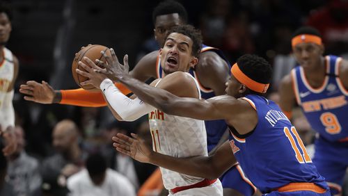 Atlanta Hawks guard Trae Young (11) is covered by New York Knicks guard Frank Ntilikina (11) during the second half Wednesday, March 11, 2020, at State Farm Arena in Atlanta.