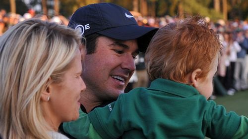 Trevor Immelman hugs his wife and son on 18 green during final round play at The Masters in Augusta, Ga on Sunday, April 13, 2008. Rich Addicks / AJC