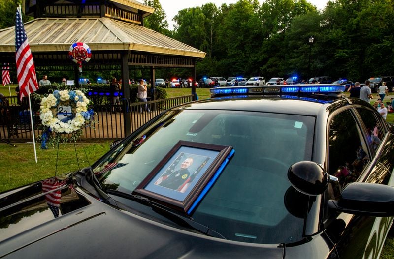 Members of the Holly Springs community and neighboring police departments gathered at Barrett Park for a candlelight vigil for Police Officer Joe Burson on Friday, June 18, 2021 after he was killed during a traffic stop. Jenni Girtman for The Atlanta Journal-Constitution