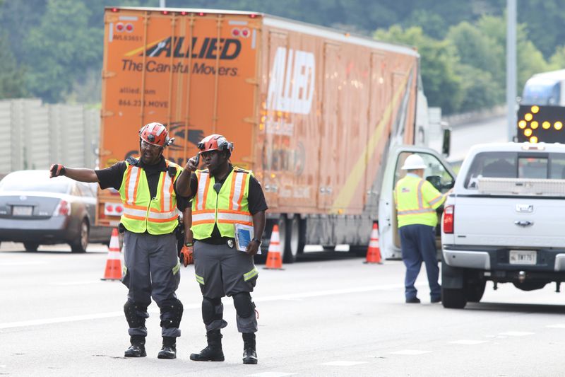 H.E.R.O. unit operators helped with traffic on I-20 near the I-285 North exit on Tuesday. Plywood scattered in the road caused workers to shut down multiple right lanes. They worked to clear the debris throughout the morning. 