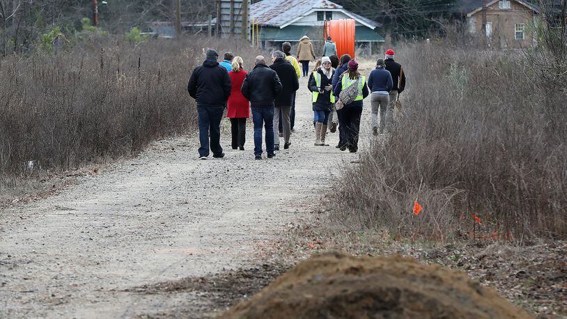 Local residents walk on an undeveloped portion of the Beltline in the Pittsburgh community, a segment where construction work will soon begin. The newest portion of the trail will connect the Eastside and Westside trail corridors. Curtis Compton ccompton@ajc.com