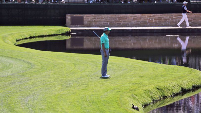 Sergio Garcia looks into the pond where he hit five balls into the water on 15 during the first round of the Masters at Augusta National Golf Club.
