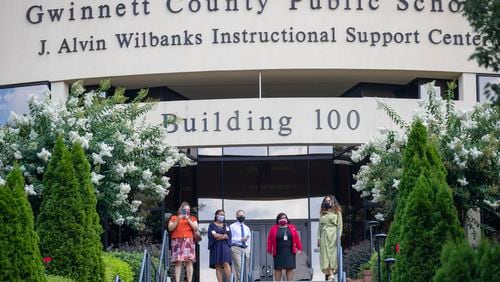 Gwinnett County Public School administration listens as demonstrators speak during a rally created by the Gwinnett Educators for Equity and Justice outside of the Gwinnett County Public School building in Suwanee, July 20. (ALYSSA POINTER / ALYSSA.POINTER@AJC.COM)
