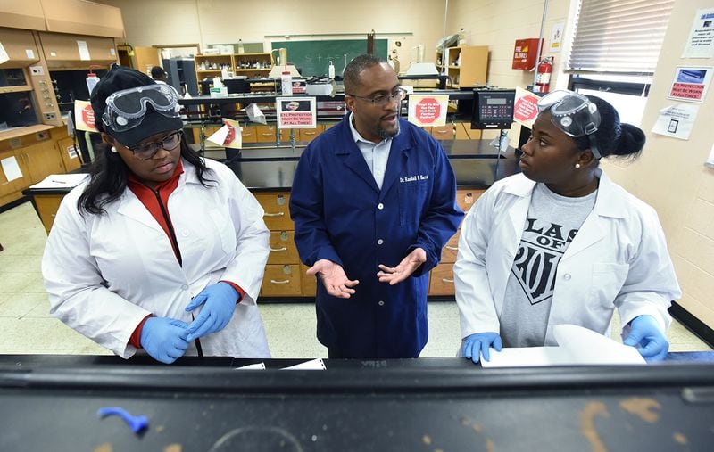 Dr. Randall Harris, assistant professor of Chemistry, helps students in a lab at Claflin University. Close to 300,000 students attend HBCUs (HYOSUB SHIN / HSHIN@AJC.COM)