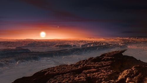 This artist rendering provided by the European Southern Observatory shows a view of the surface of the planet Proxima b orbiting the red dwarf star Proxima Centauri, the closest star to the solar system.
