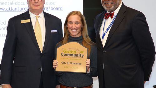 Suwanee City Planner Jylie Adams, center, poses with Atlanta Regional Commission Chariman Kerry Armstrong, left, and Executive Director Doug Hooker after receiving the city’s Green Community recognition. Courtesy City of Suwanee
