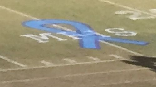 Painted on the 25-yard line at Norcross' Blue Devil Stadium was a blue ribbon with the letters "MHS" to honor the four Meadowcreek students involved in a tragic car crash on Oct. 27. Norcross hosted Meadowcreek for a high school football game on Friday. (photo credit Alex Makrides)