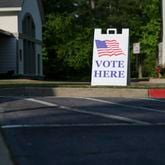 An “Vote Here” sign outside a Cobb County polling location on Monday, May 2, 2022. Early voting begins Monday for voters that want to cast ballots before election day on May 24. (Natrice Miller / natrice.miller@ajc.com)