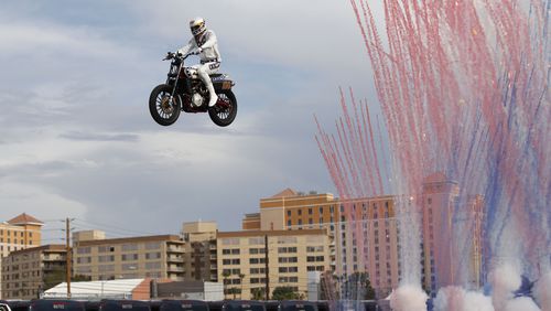 Travis Pastrana jumps a row of crushed cars on a motorcycle Sunday, July 8, 2018, in Las Vegas.