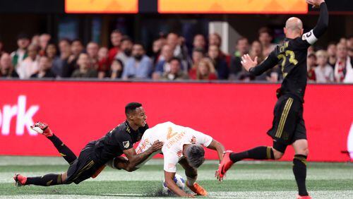 April 7, 2018.  Atlanta United forward Josef Martinez gets tackle from behind from a Los Angeles FC defender.