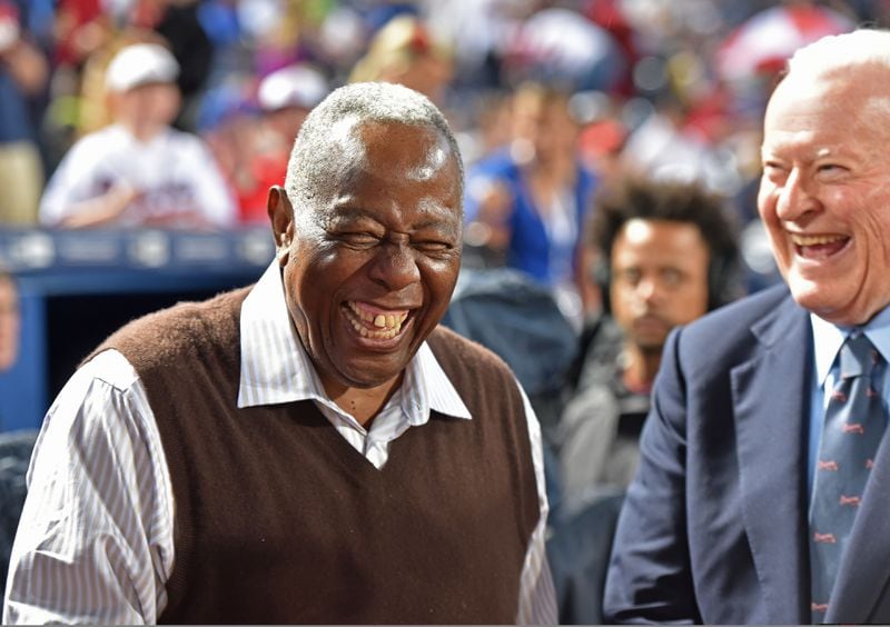Bill Bartholomay, who frequently attended Braves games through last season, shares a laugh with Hank Aaron. 