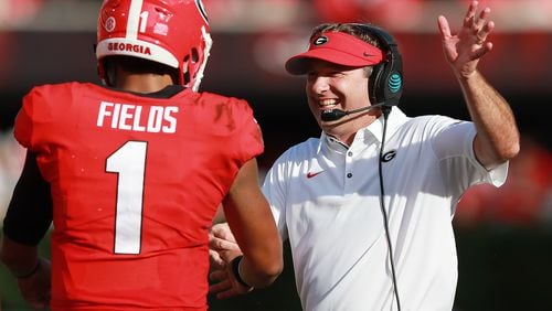 In happy times, Georgia head coach Kirby Smart celebrates a touchdown against Tennessee with quarterback Justin Fields.
