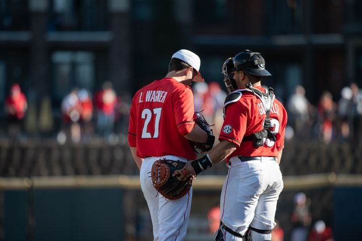 Bulldogs catcher Fernando Gonzalez and pitcher Luke Wagner have a chat during the 20th Spring Classic against Georgia Tech on Sunday at Coolray Field in Lawrenceville. (Jamie Spaar / for The Atlanta Journal-Constitution)