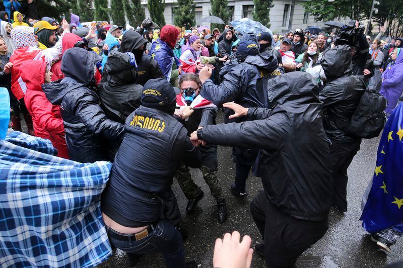 Police try to detain demonstrators near the Parliament building during an opposition protest against "the Russian law" in the center of Tbilisi, Georgia, on Monday, May 13, 2024. Daily protests are continuing against a proposed bill that critics say would stifle media freedom and obstruct the country's bid to join the European Union. (AP Photo/Zurab Tsertsvadze)
