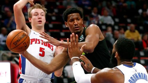 Atlanta Hawks' Andrew White III drives on Detroit Pistons center Andre Drummond (0) as Luke Kennard (5) defends in the first half of an NBA basketball game in Detroit, Wednesday, Feb. 14, 2018. (AP Photo/Paul Sancya)
