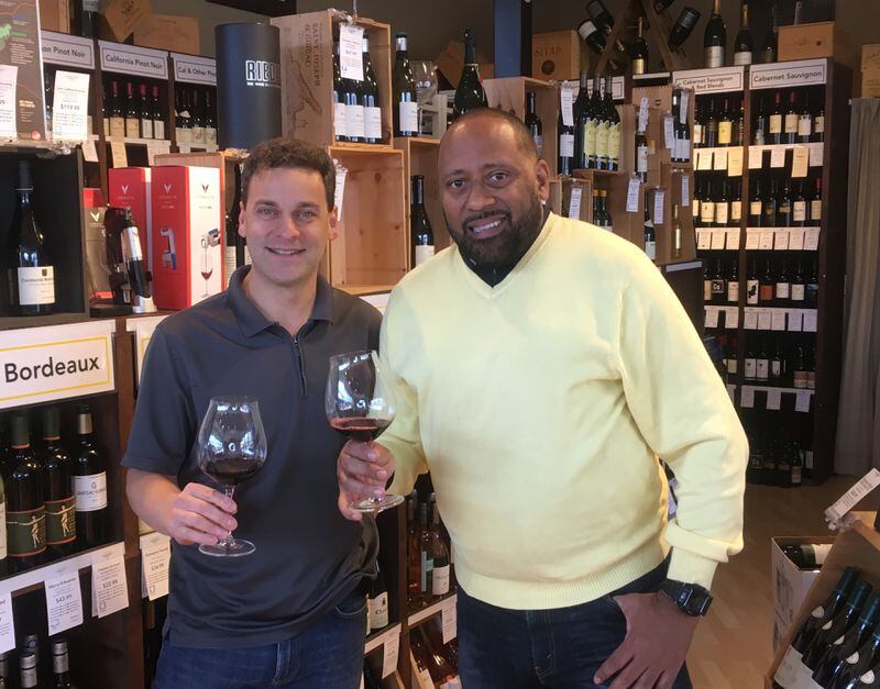  Highland Fine Wine owner Nick Salpekar, left, and Frank Ski do a little research ahead of the upcoming Frank Ski Kids Foundation charity wine tasting and auction. Photo: Jennifer Brett