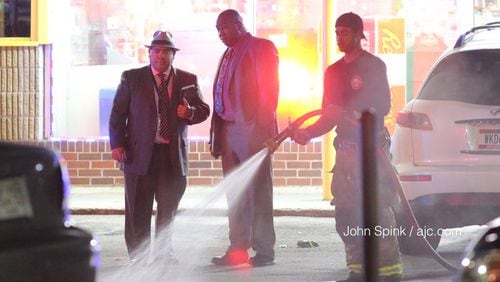 Police are investigating a shooting that left one man dead and another injured at a discount food mart in southwest Atlanta.  JOHN SPINK / JSPINK@AJC.COM