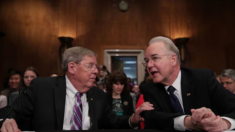 WASHINGTON, DC -U.S. Health and Human Services Secretary Nominee Rep. Tom Price (R-GA) (R) talks to Sen. Johnny Isakson (R-GA) (L) during his confirmation hearing January 18, 2017 on Capitol Hill in Washington, DC.  (Photo by Alex Wong/Getty Images)