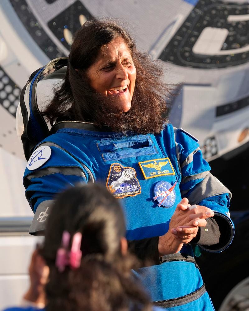 NASA astronaut Suni Williams laughs with relatives as she leaves the Operations and Checkout building before heading to Space Launch Complex 41 to board the Boeing's Starliner capsule atop an Atlas V rocket for a mission to the International Space Station at the Cape Canaveral Space Force Station, Monday, May 6, 2024, in Cape Canaveral, Fla. (AP Photo/John Raoux)