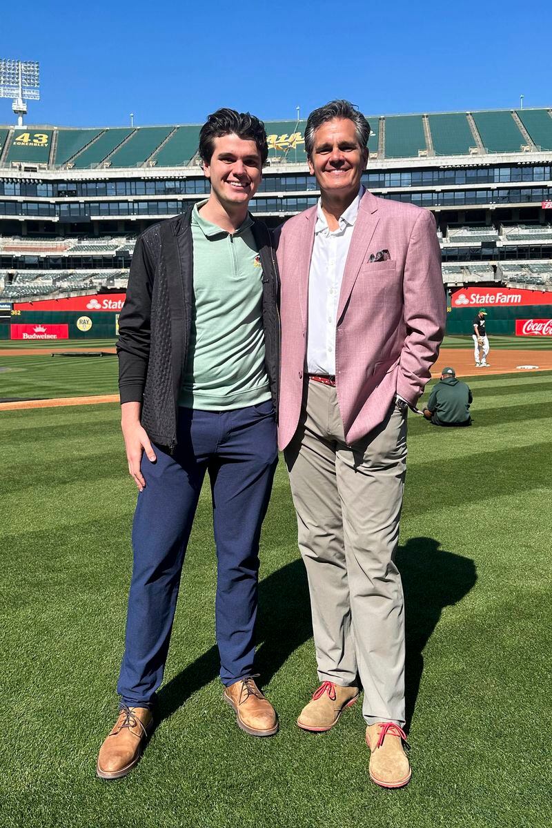 Oakland Athletics broadcaster Chris Caray, left, and his father, Chip, the play-by-play announcer for the St. Louis Cardinals, stand for a photo before the teams' baseball game Monday, April 15, 2024, in Oakland, Calif.(AP Photo/Janie McCauley)