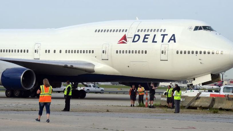 Crews move a retired Boeing 747-400 to the Delta Flight museum in April 2016. KENT D. JOHNSON /kdjohnson@ajc.com